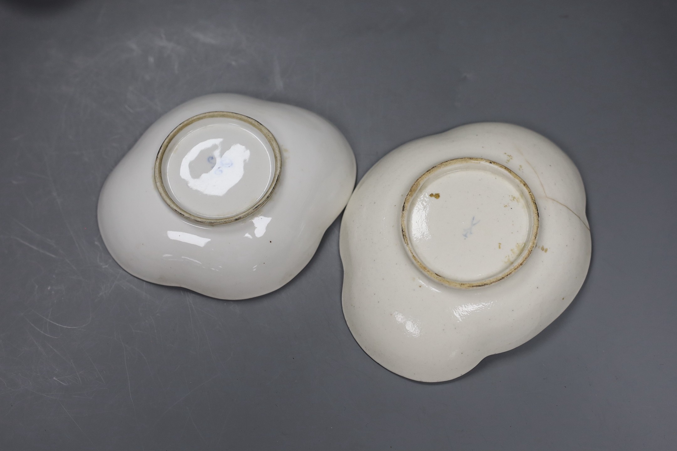 Two Berlin figural salts, 13cm high together with two Dresden saucers and a continental figurine
